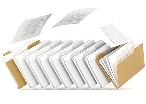 A picture of several partly-open file folders with some documents flying out