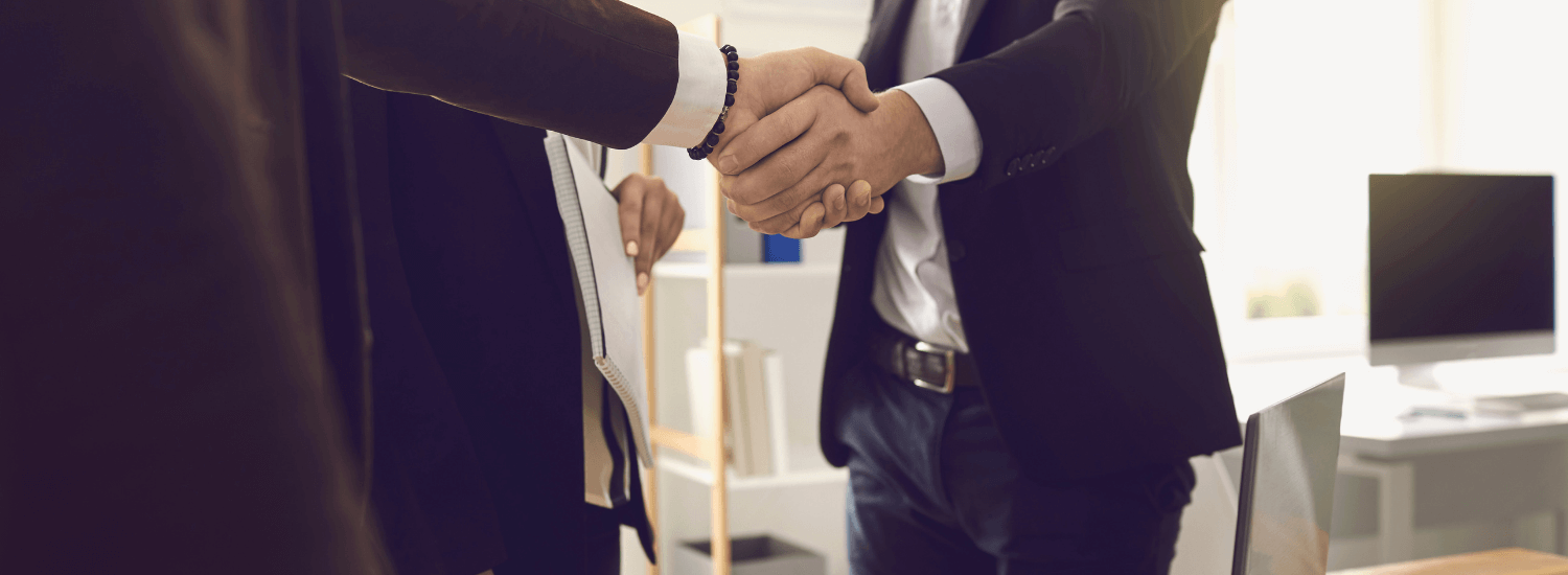 insurance professionals shake hands after viewing demo of SubroCheck